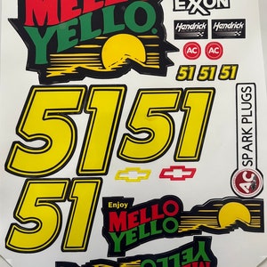 May include: A set of NASCAR racing car decals featuring the Mello Yello brand logo, the number 51, and the words "Enjoy Mello Yello". The decals are in yellow, red, green, and black.