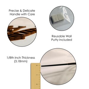 May include: A brown wooden cutout with a laser-cut edge, accompanied by a small plastic bag containing two squares of reusable wall putty. A wooden ruler shows the material has a thickness of 1/8th inch, which is equivalent to 3.18mm.