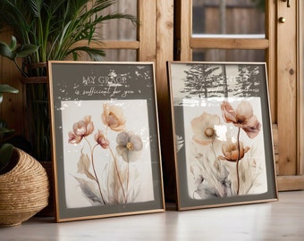 May include: Two framed floral prints with inspirational quotes. The left print features a watercolour painting of pink and white flowers with the quote "My grace is sufficient for you". The right print features a watercolour painting of pink and white flowers with the quote "My strength is made perfect in weakness".
