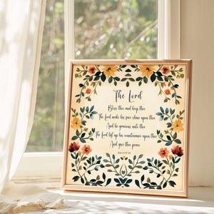 May include: A framed print with a floral border and a vintage-style background. The print features a bible verse from Psalm 29:20, "The Lord bless thee and keep thee; the Lord make his face shine upon thee, and be gracious unto thee: the Lord lift up his countenance upon thee, and give thee peace."