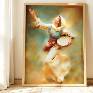 May include: A framed print of a woman in traditional attire, dancing with a tambourine. The artwork features a warm color palette with shades of yellow, blue, and red. The woman is wearing a headscarf and a long flowing dress.