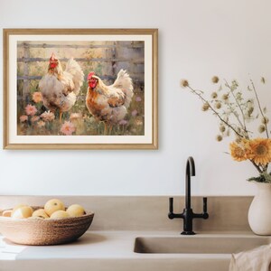 Peut inclure: Une peinture &agrave; l'aquarelle encadr&eacute;e repr&eacute;sente deux poulets dans un jardin. Les poulets ont des plumes blanches et brunes et des cr&ecirc;tes rouges. Des fleurs roses et une cl&ocirc;ture en bois sont en arri&egrave;re-plan. Le tableau est dans un cadre en bois brun clair.