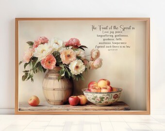 May include: A framed print with a painting of a vase of pink and white flowers with red apples in a bowl on a wooden table. The print includes a quote from the Bible: "The Fruit of the Spirit is Love, joy, peace, longsuffering, gentleness, goodness, faith, meekness, temperance. Against such there is no law. Gal 5:22-23"