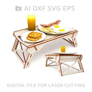 May include: A white wooden folding tray table with a brown trim. The tray table is set with a plate of bacon and eggs, a plate of toast, and a glass of orange juice. The tray table is designed for laser cutting.