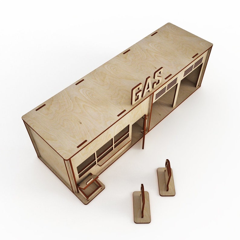 May include: A wooden model of a gas station with a sign that reads "GAS" and two gas pumps. The model is made of plywood and has a brown finish.