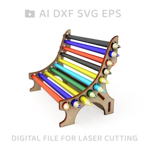 May include: A wooden pencil holder with a curved design, holding a variety of coloured pencils. The holder is made for laser cutting.
