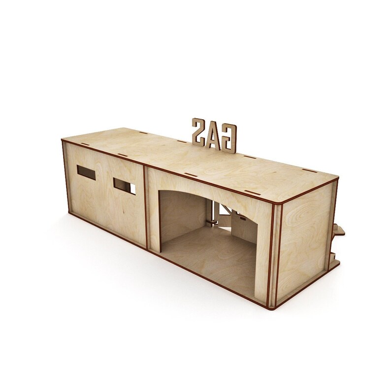 May include: A wooden model of a gas station with a sign that reads "GAS" on the roof. The model has a garage door that is open and a small window on the side.