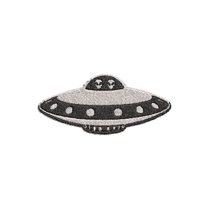 May include: A black and white embroidered patch of a UFO with two alien faces inside. The UFO has a rounded top and a flat bottom with a black rim and white dots.