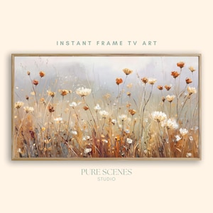 Może przedstawiać: Oprawiony obraz kwiatowy w neutralnej palecie kolorów. Dzieło przedstawia białe i pomarańczowe kwiaty na polu wysokiej trawy. Widoczne są napisy "INSTANT FRAME TV ART" i "PURE SCENES STUDIO".