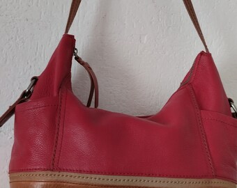 The SAK leather shoulder vintage bag.Orange and brown.