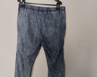 Denim acid wash capris,size large.Denim is soft.Elastic waistband and on bottom of pants.Fake zipper.