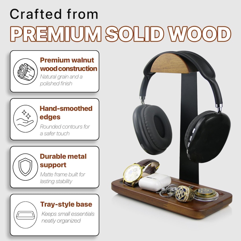 May include: A headphone stand featuring a walnut wood top arch and a rectangular walnut wood tray base connected by a black metal support. The stand holds black over-ear headphones, a wristwatch, white earbuds, a ring, and a small circular object.