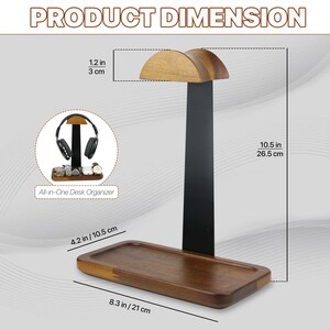 May include: A wooden and black metal headphone stand with a rectangular base tray. The stand measures 10.5 inches tall, 8.3 inches wide, and 4.2 inches deep, with a 1.2-inch wide top rest. An inset shows the stand holding headphones and accessories.