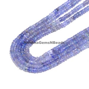 May include: A strand of blue gemstone beads. The beads are faceted and have a slightly irregular shape. The beads are strung on a clear thread and are ready to be used for jewelry making.