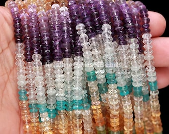 May include: A strand of multi-colored gemstone beads, including amethyst, aquamarine, and citrine. The beads are faceted and have a round shape. The strand is approximately 16 inches long.