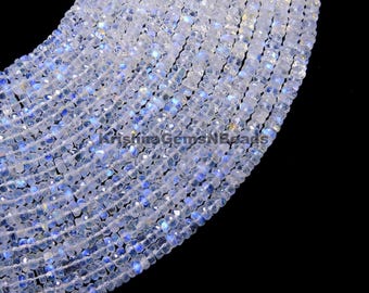 May include: A strand of white moonstone beads with a faceted, square shape. The beads have a subtle iridescent shimmer.