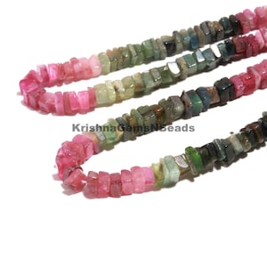 May include: Strands of colourful tourmaline beads in shades of pink, green, and black. The beads are rectangular and strung together, creating a vibrant gemstone necklace or bracelet.