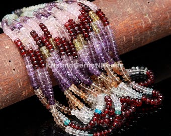 May include: A multi-colored strand of gemstone beads. The beads are faceted and have a variety of colors, including pink, purple, green, and brown. The beads are strung on a clear thread and are arranged in a repeating pattern.