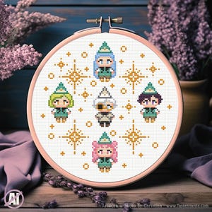 May include: A cross-stitch embroidery hoop featuring six cartoon figures with various hair colors and outfits, surrounded by gold starbursts. The figures are wearing green hats and outfits. The hoop is set against a wooden background with lavender accents.
