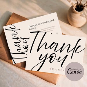 Puede incluir: Dos tarjetas de agradecimiento color crema con texto negro en cursiva. Las tarjetas dicen "Thank you" en letra grande, con texto más pequeño debajo. Un sobre marrón y un pequeño jarrón con flores secas están en el fondo. Las tarjetas dicen "Made in Canva".