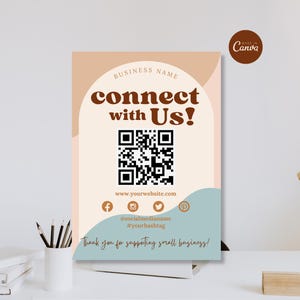 May include: A rectangular sign featuring the text connect with Us! in brown, a central QR code, and social media icons. The design includes a cream arch, a blue wave at the bottom, and the text Thank you for supporting small business! in script.