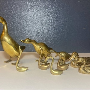 Vintage set of 9 solid brass birds — ducks, geese, and swans — likely made in Asia. Classic mid-century style with elegant patina.