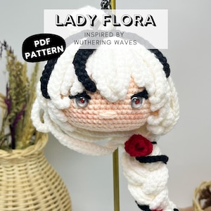 May include: A handmade crochet doll with white hair and black accents, inspired by Wuthering Waves. The doll has a red rose and the text "LADY FLORA" and "PDF PATTERN" are visible.
