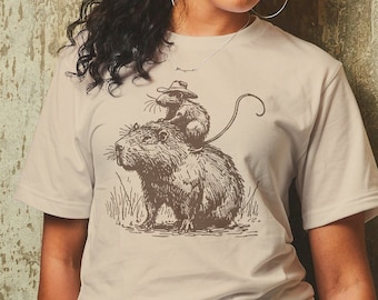 Rata montando una camisa de capibara, camiseta de arte animal, camiseta de rata vaquera, regalo divertido de capibara, camisas de roedores, regalo de mordaza, camisa de meme de rata, regalo de novedad
