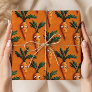May include: Gift wrap featuring a repeating pattern of smiling cartoon carrots with green tops on an orange background. The wrapped package is tied with twine. The overall theme is food and vegetables.