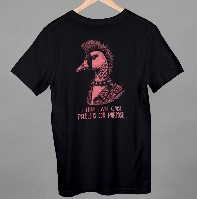 May include: Black t-shirt with a pink illustration of a punk rock goose with a mohawk and the text "I think I will cause problems on purpose."