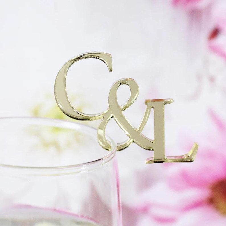 "Elegant custom wedding drink toppers in acrylic for champagne and wine glasses."