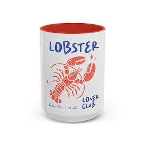 May include: White ceramic mug with a red rim. The mug features a red lobster illustration with the text "Lobster Lover Club" and "Pinch Me, I'm in!" in blue.