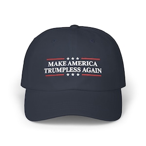 May include: Navy blue baseball cap with the text "MAKE AMERICA TRUMPLESS AGAIN" in white and red. The text is centered on the front of the cap, with stars above and below the text.