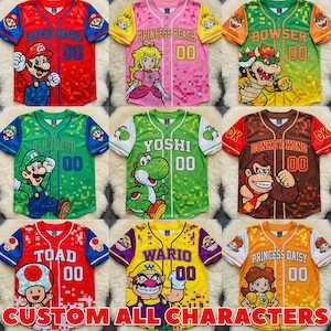 May include: A collection of nine button-down baseball jerseys featuring various Super Mario characters including Mario, Princess Peach, Bowser, Luigi, Yoshi, Donkey Kong, Toad, Wario, and Princess Daisy, each with a pixelated pattern and the number 00.