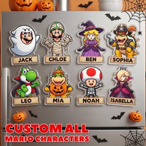K&ouml;nnte beinhalten: Acht personalisierte K&uuml;hlschrankmagnete aus Acryl mit Mario-Charakteren in Halloween-Kost&uuml;men: Jack als Geist, Chloe als Mumie, Ben als Hexe, Sophia als Pirat, Leo als Vampir, Mia als K&uuml;rbis, Noah als Skelett und Isabella als Prinzessin.