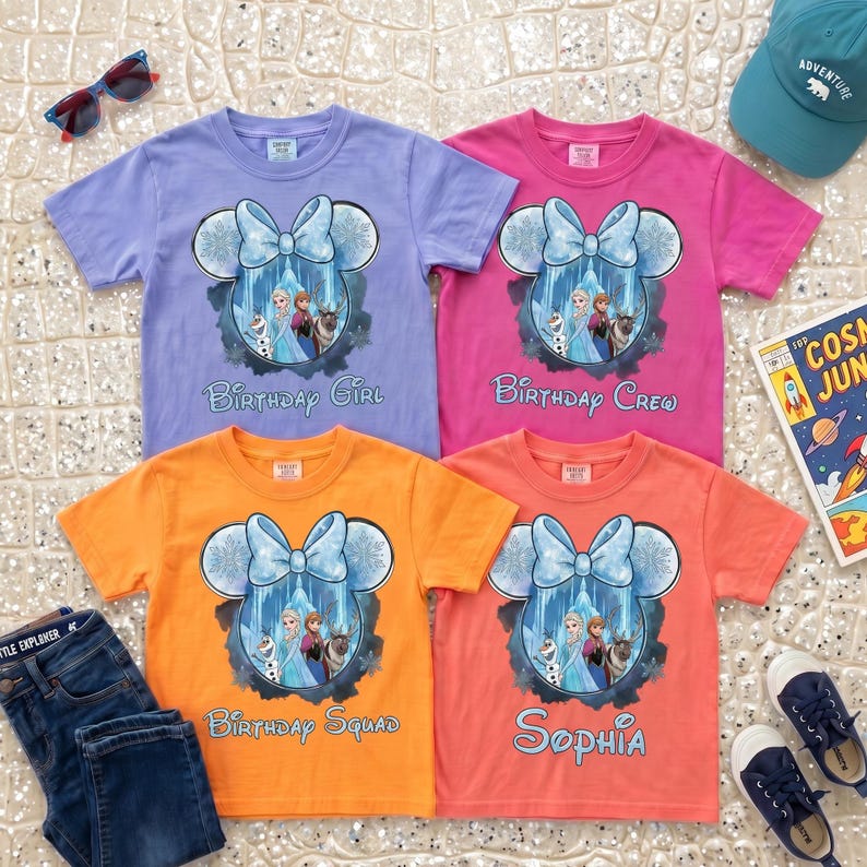 May include: Four short-sleeve t-shirts in light purple, pink, orange, and coral. Each features a graphic of a Mickey Mouse-shaped silhouette with a blue bow, containing characters from Frozen, with text reading Birthday Girl, Birthday Crew, Birthday Squad, and Sophia.