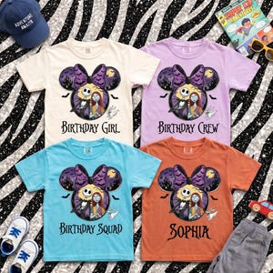 May include: Four short-sleeve t-shirts in cream, light purple, light blue, and orange. Each features a graphic of Jack Skellington and Sally inside a Mickey Mouse ear silhouette with a purple bow, bats, and the text Birthday Girl, Crew, Squad, or Sophia.