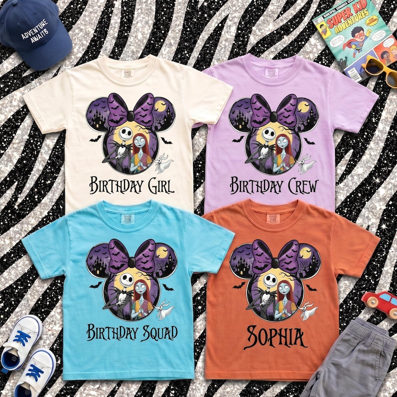 May include: Four short-sleeve t-shirts in cream, light purple, light blue, and orange. Each features a graphic of Jack Skellington and Sally inside a Mickey Mouse ear silhouette with a purple bow, bats, and the text Birthday Girl, Crew, Squad, or Sophia.