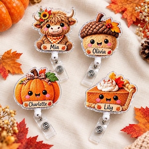 May include: Four acrylic badge reels featuring autumn-themed characters: a Highland cow named Mia, an acorn named Olivia, a pumpkin named Charlotte, and a slice of pumpkin pie named Lily. Each piece has a clear clip and a personalized name tag.