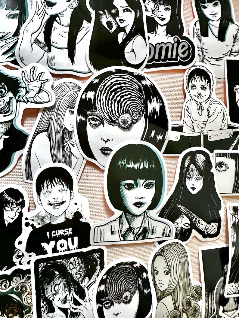 May include: A collection of black and white horror-themed stickers featuring characters with spiral eyes, a girl with a knife, and a boy with the text "I curse you".