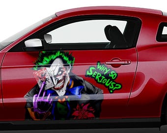 May include: A red car with a Joker graphic on the side. The graphic includes the Joker's face, a playing card, and the text "Why so serious?"
