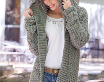 May include: A grey hooded cardigan with a textured stitch pattern. The cardigan is open at the front and has a long, flowing style.