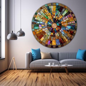 May include: A circular wall art piece with a mosaic design. The mosaic is made up of small, colorful squares and rectangles. The colors are mostly warm, with shades of yellow, orange, red, brown, and green. The mosaic is arranged in a radial pattern, with the center of the circle being the focal point.