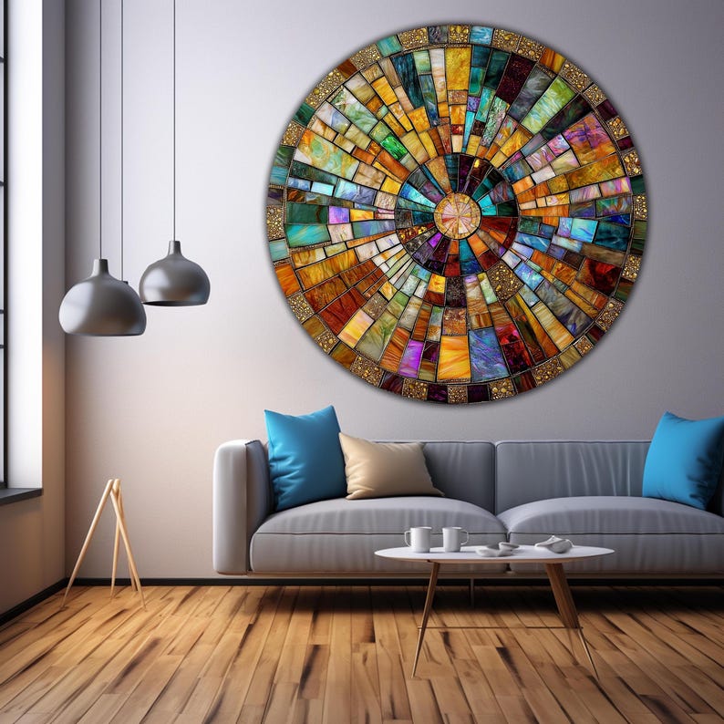 May include: A circular wall art piece with a mosaic design. The mosaic is made up of small, colorful squares and rectangles. The colors are mostly warm, with shades of yellow, orange, red, brown, and green. The mosaic is arranged in a radial pattern, with the center of the circle being the focal point.