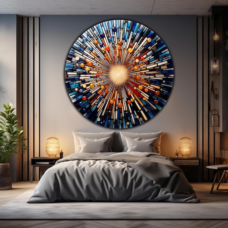 May include: A large, round, abstract wall art piece with a burst of color in the center. The artwork is made of various shades of blue, orange, and yellow, and has a textured, mosaic-like appearance.