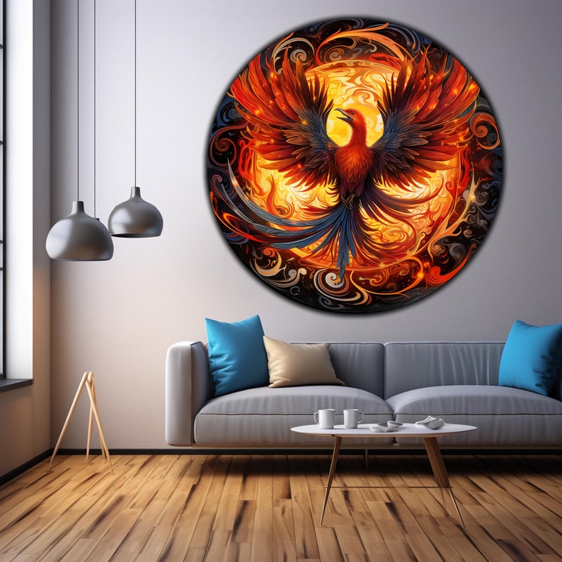 May include: A circular wall art piece featuring a phoenix rising from flames. The phoenix is depicted in shades of orange, red, and yellow, with black and blue accents. The background is a swirling pattern of black, orange, and yellow.