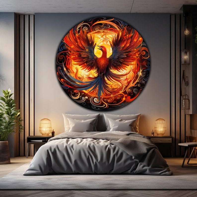 May include: A circular wall art piece featuring a phoenix rising from flames. The phoenix is depicted in shades of red, orange, and yellow, with blue and black accents. The background is a swirling pattern of black, white, and gray.