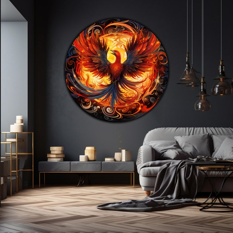 May include: A circular wall art piece featuring a stylized phoenix rising from flames. The phoenix is depicted in shades of red, orange, and yellow, with blue accents. The background is a swirling pattern of black, gray, and white.
