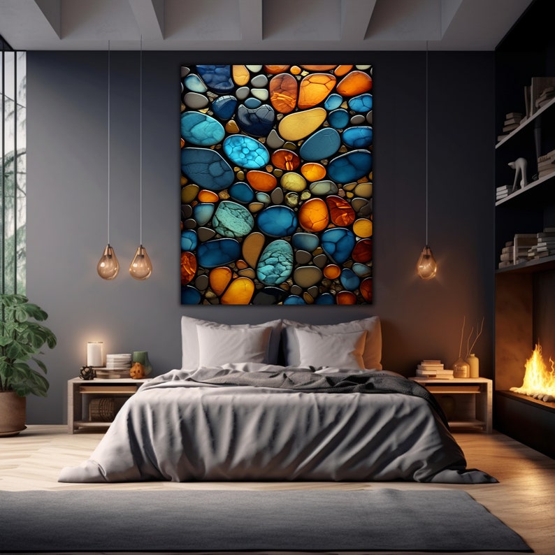 May include: A modern bedroom interior with a large abstract wall art featuring a mosaic of colorful, round, glass-like shapes in shades of blue, orange, and yellow. The artwork is hung above a gray bed with white pillows and a gray blanket.
