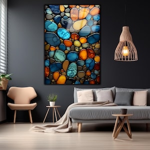 May include: Abstract wall art featuring a close-up of colorful, smooth, round stones in shades of blue, green, orange, and brown.